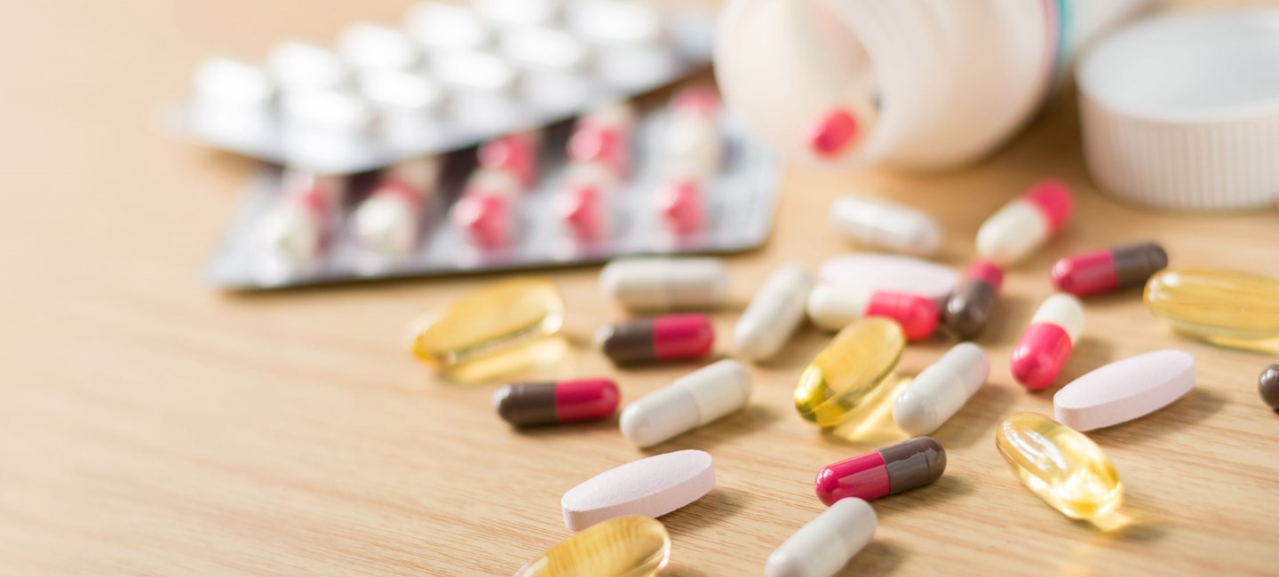 An image showing various pills spilled out on table
